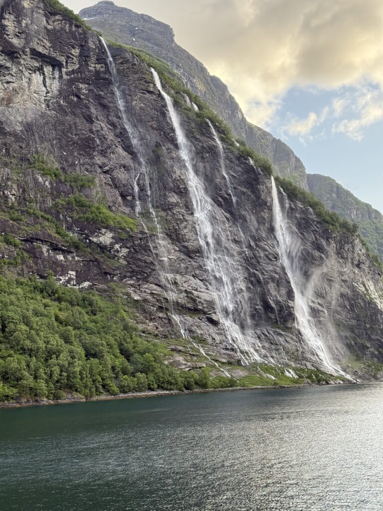 Geiranger fjord waterfall views on our Norway travel adventure.