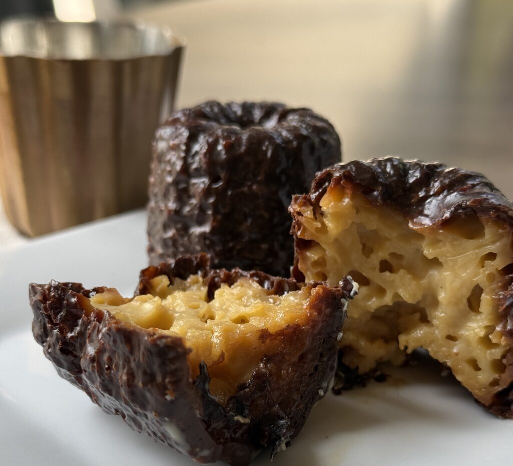 Traditional French canelés baked in copper molds from E. Dehillerin in Paris