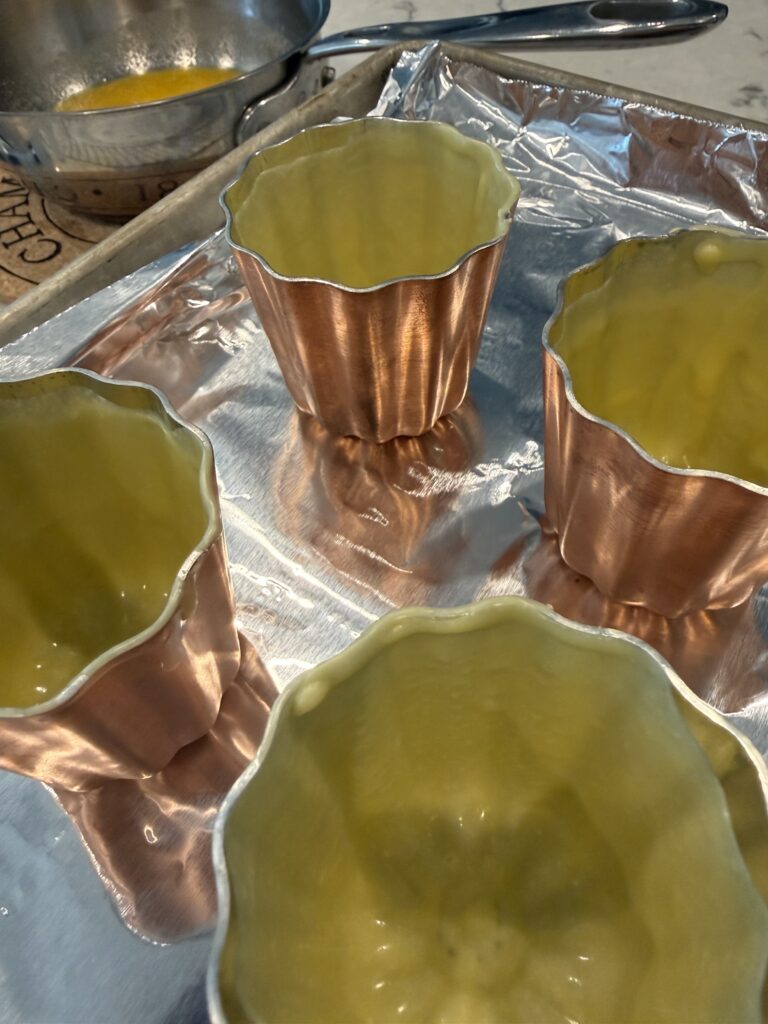 Copper canelé molds coated with beeswax
